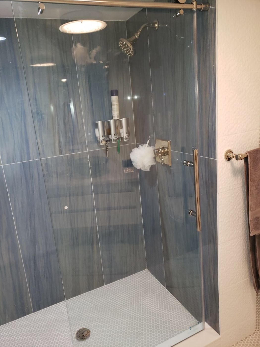 Blue tile shower with frameless glass